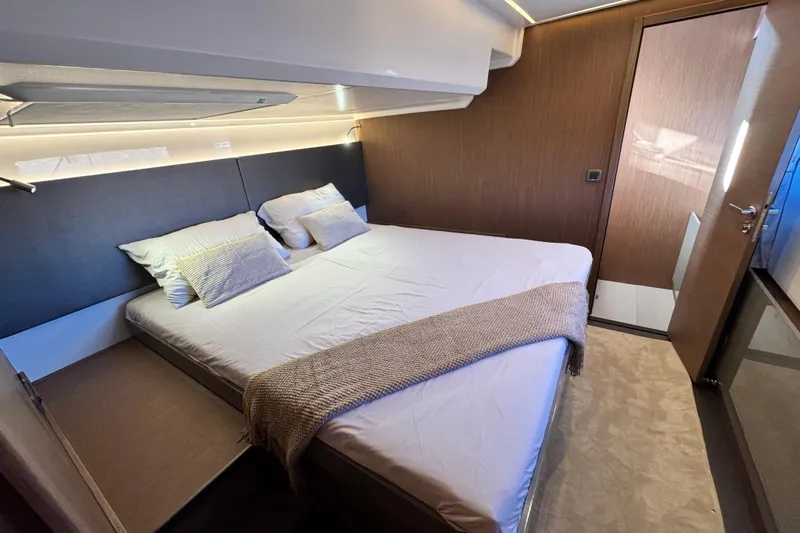  Yacht Photos Pics Luxurious bedroom interior of 2024 Prestige M48 yacht with modern design and cozy bedding.