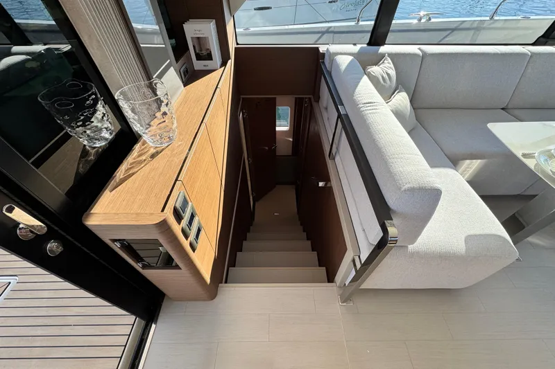  Yacht Photos Pics Interior of 2024 Prestige M48 yacht with modern staircase and elegant seating area.