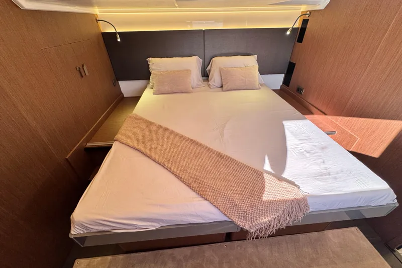  Yacht Photos Pics Luxurious bedroom interior of 2024 Prestige M48 yacht with elegant bedding and ambient lighting.