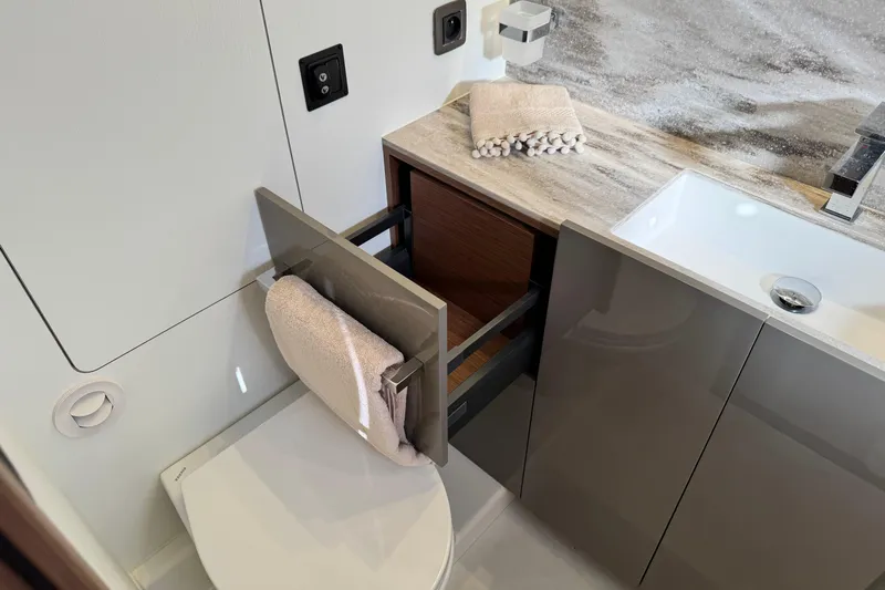  Yacht Photos Pics 2024 Prestige M48 bathroom with modern sink, towel rack, and storage drawer.