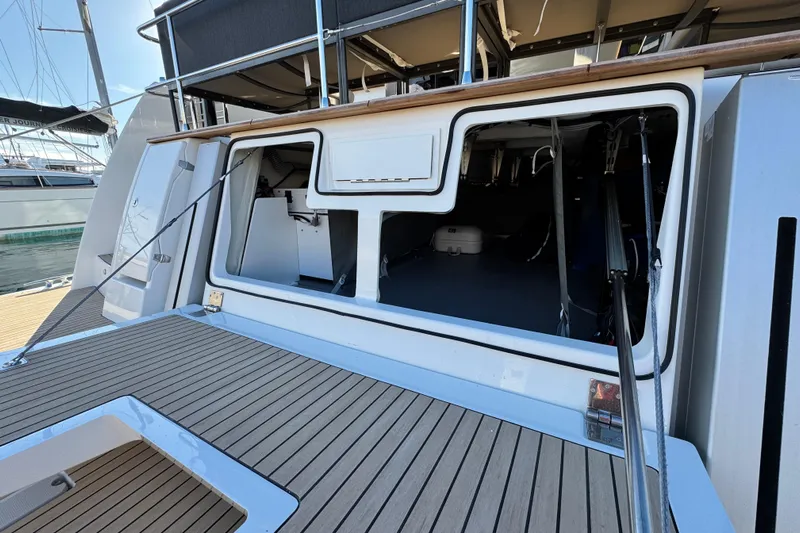  Yacht Photos Pics 2024 Prestige M48 yacht with open storage compartment, docked at marina.