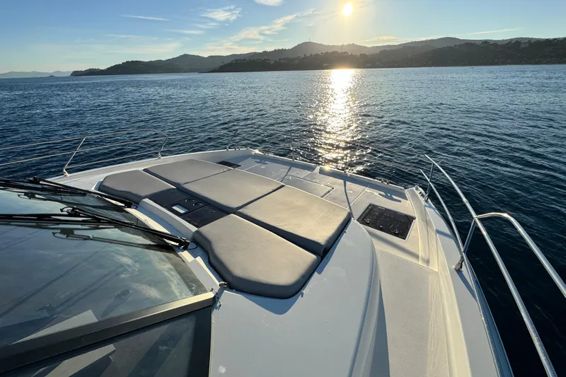  Yacht Photos Pics 2024 Prestige M48 yacht deck with sun loungers, ocean view, and sunset.