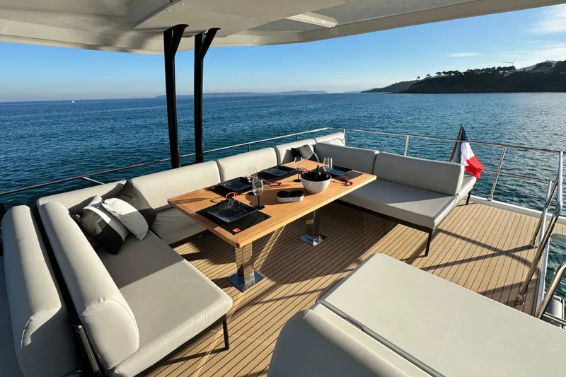  Yacht Photos Pics Luxurious 2024 Prestige M48 yacht deck with elegant dining setup and ocean view.