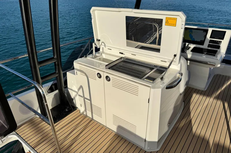  Yacht Photos Pics Outdoor kitchen on 2024 Prestige M48 yacht with grill and navigation controls.
