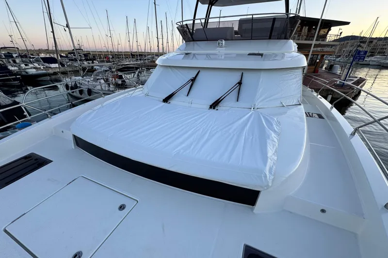  Yacht Photos Pics 2024 Prestige M48 yacht docked at marina during sunset, showcasing sleek design and spacious deck.