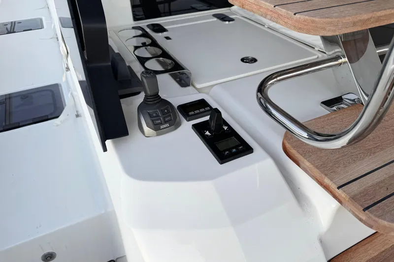 Yacht Photos Pics Control panel of 2024 Prestige M48 yacht with joystick and wooden accents.
