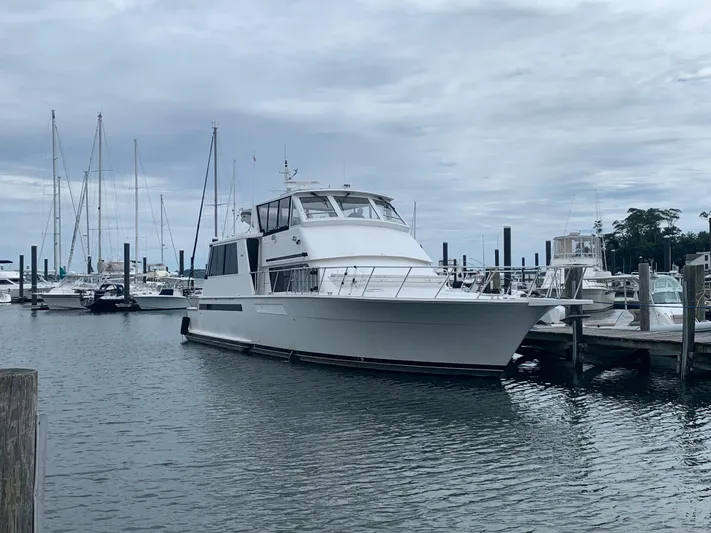 Limitless Yacht Photos Pics 1998 Viking 60 CMY yacht docked at a marina on a cloudy day.