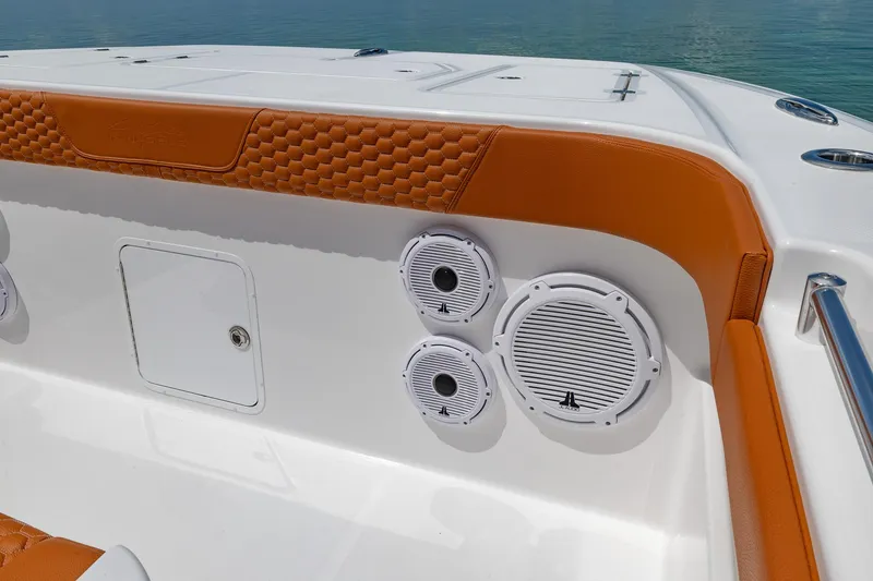  Yacht Photos Pics 2023 Invincible 46 Pilothouse boat interior with speakers and orange accents.