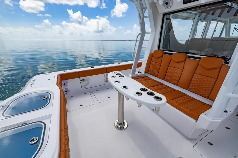  Yacht Photos Pics 2023 Invincible 46 Pilothouse boat with orange seating and ocean view.