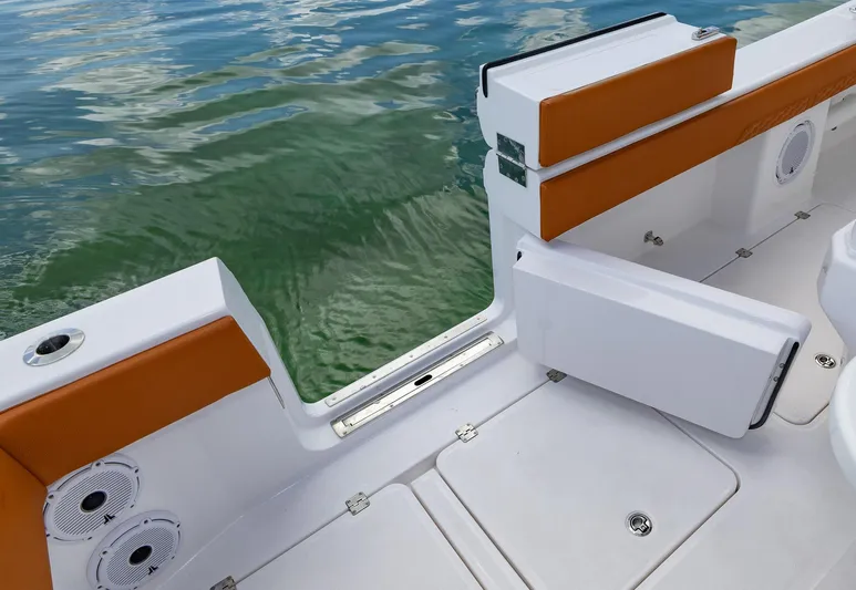  Yacht Photos Pics 2023 Invincible 46 Pilothouse boat with open side door, orange seating, and water view.