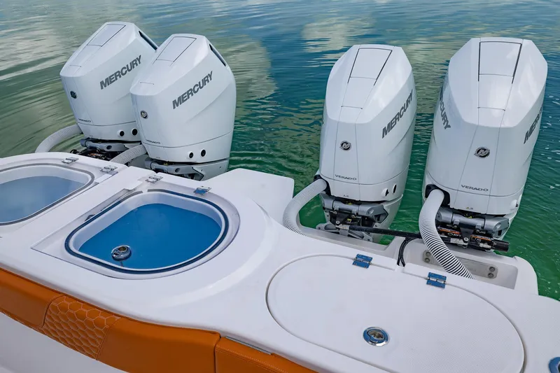  Yacht Photos Pics 2023 Invincible 46 Pilothouse with four Mercury outboard engines on calm water.