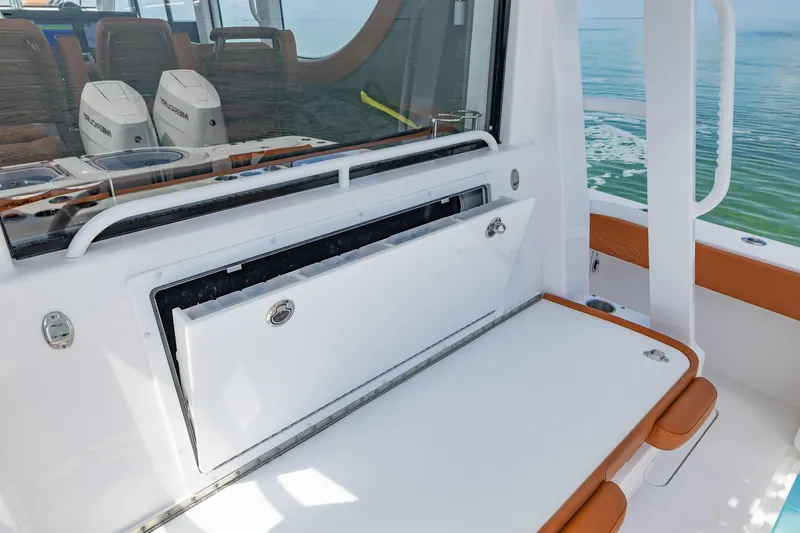  Yacht Photos Pics 2023 Invincible 46 Pilothouse interior with seating and storage, ocean view.