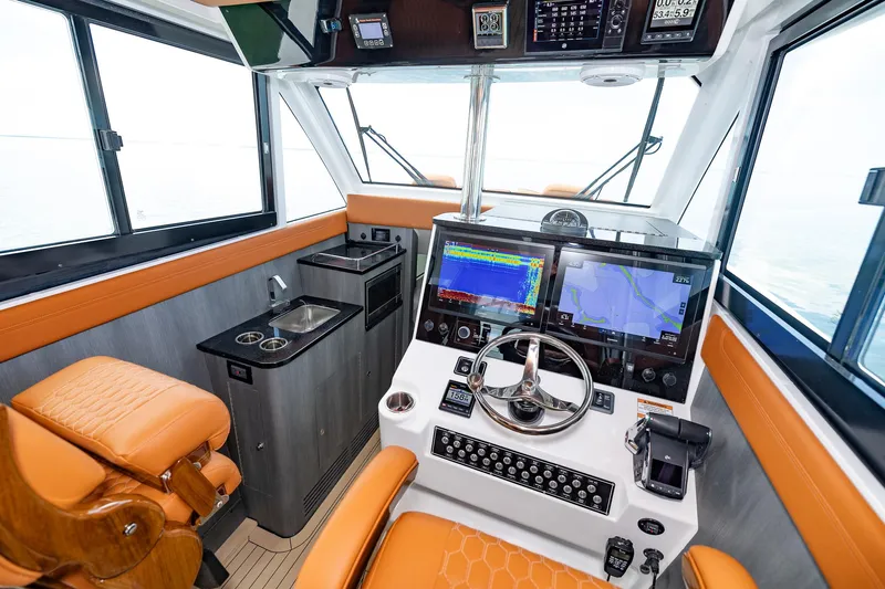  Yacht Photos Pics 2023 Invincible 46 Pilothouse interior with advanced navigation system and luxurious seating.