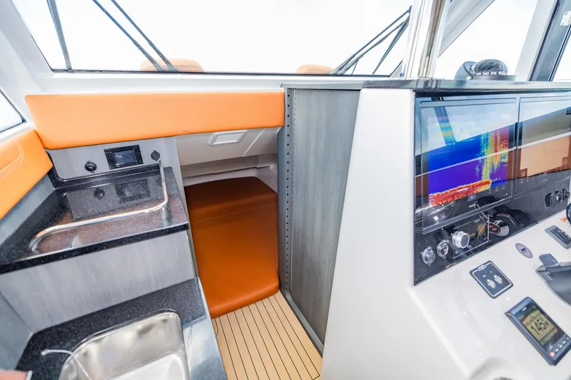  Yacht Photos Pics 2023 Invincible 46 Pilothouse interior with modern navigation equipment and sleek design.
