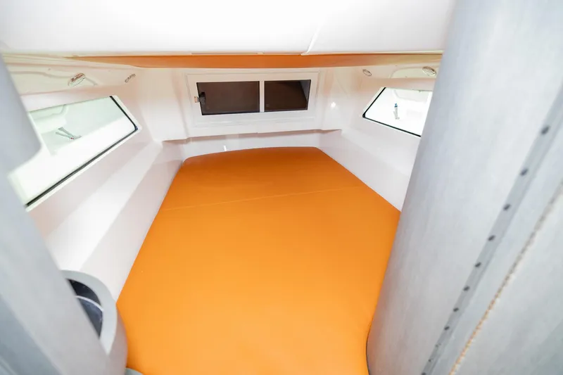  Yacht Photos Pics 2023 Invincible 46 Pilothouse interior with orange bedding and windows.