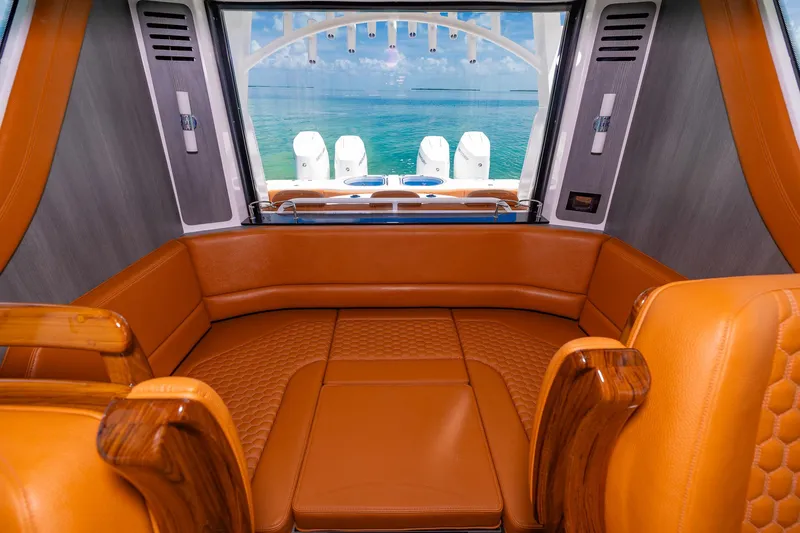  Yacht Photos Pics Luxurious interior of 2023 Invincible 46 Pilothouse with orange seating and ocean view.