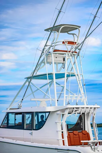  Yacht Photos Pics 2023 Invincible 46 Pilothouse boat with tower against blue sky.