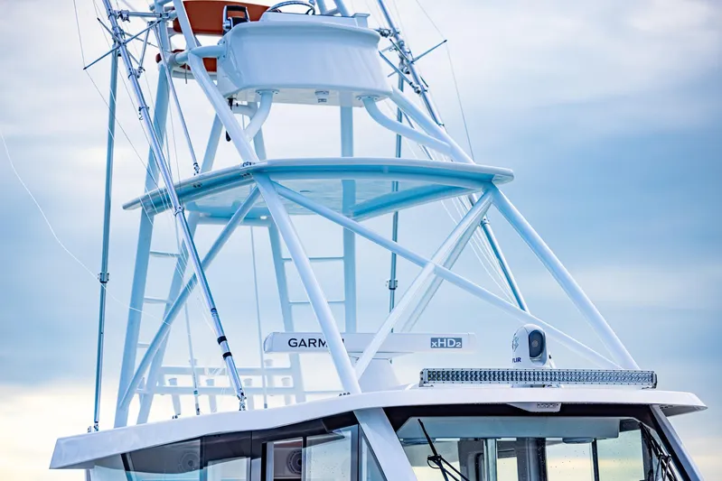  Yacht Photos Pics 2023 Invincible 46 Pilothouse boat tower against a cloudy sky.