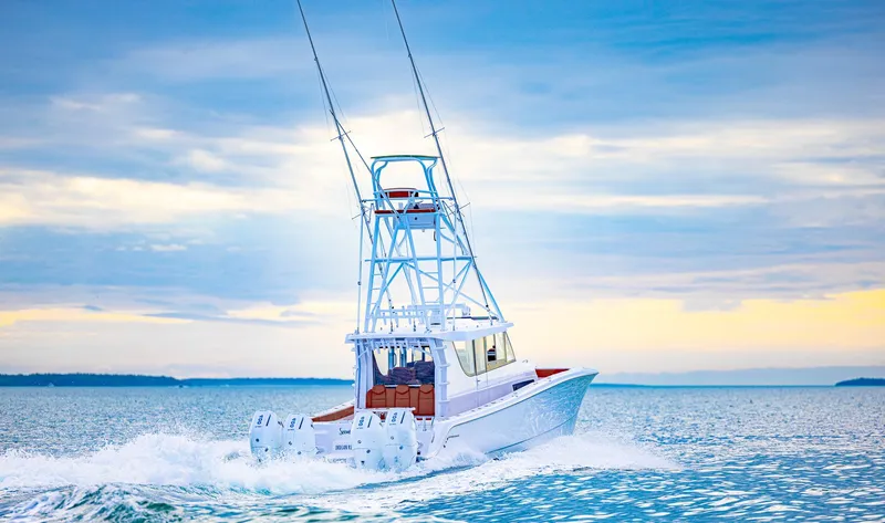 Yacht Photos Pics 2023 Invincible 46 Pilothouse boat cruising on open water under a cloudy sky.