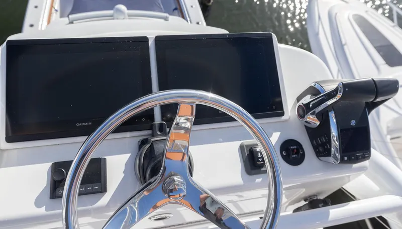  Yacht Photos Pics 2024 Invincible 46 Pilothouse helm with dual screens and controls.