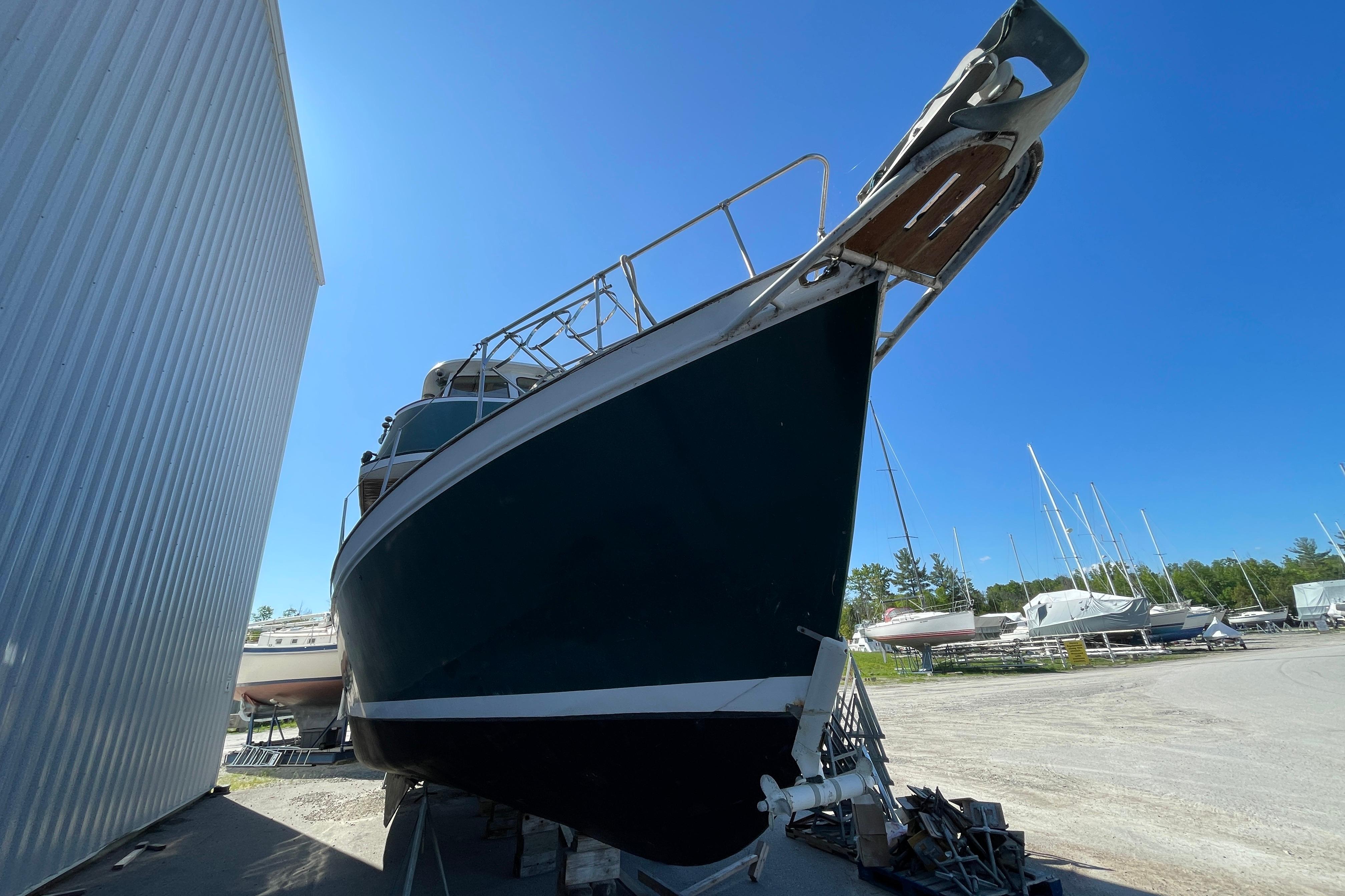 1966 Vinette 430 Trawler docked outdoors under clear blue sky.