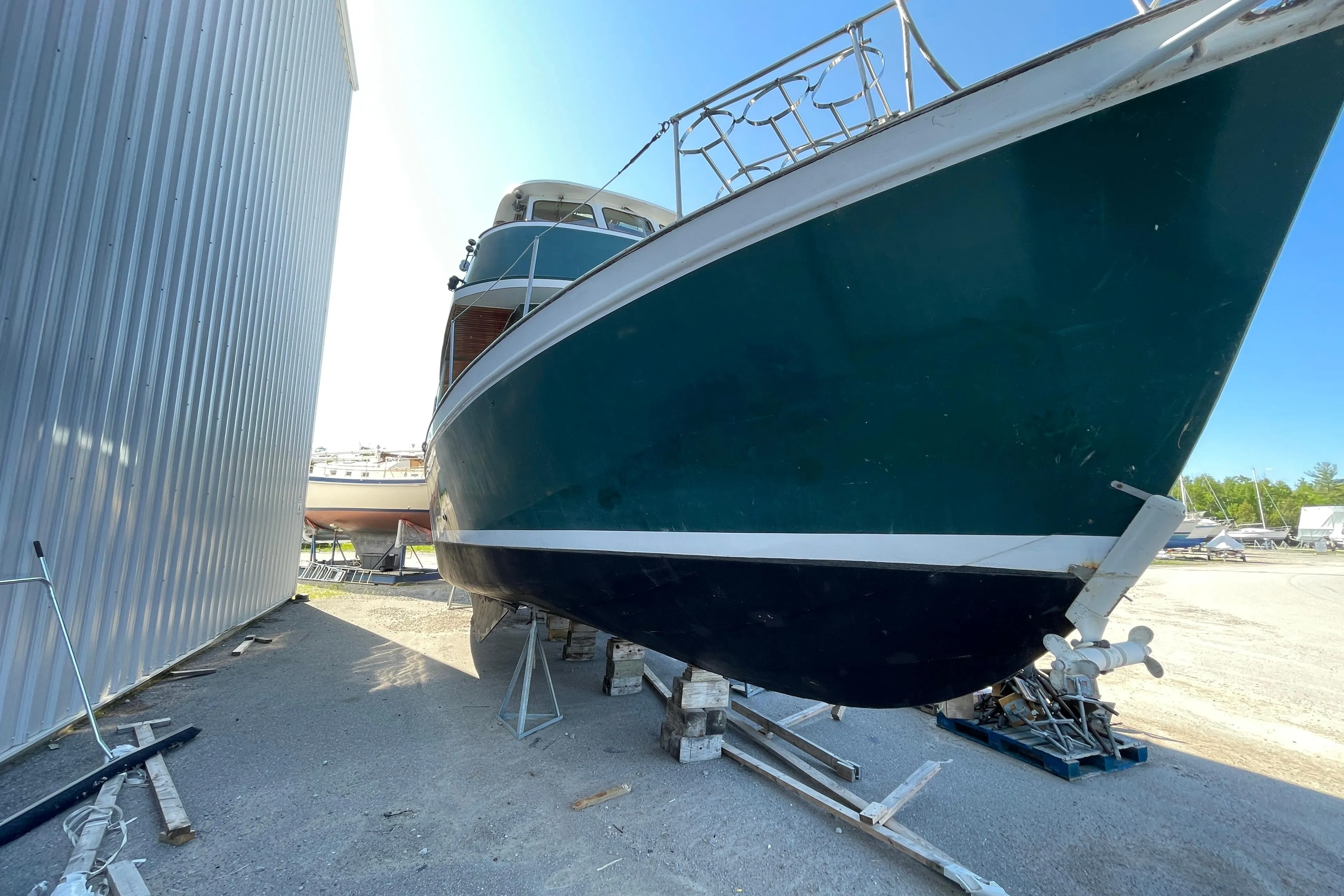 1966 Vinette 430 Trawler boat on dry dock, side view with blue hull.