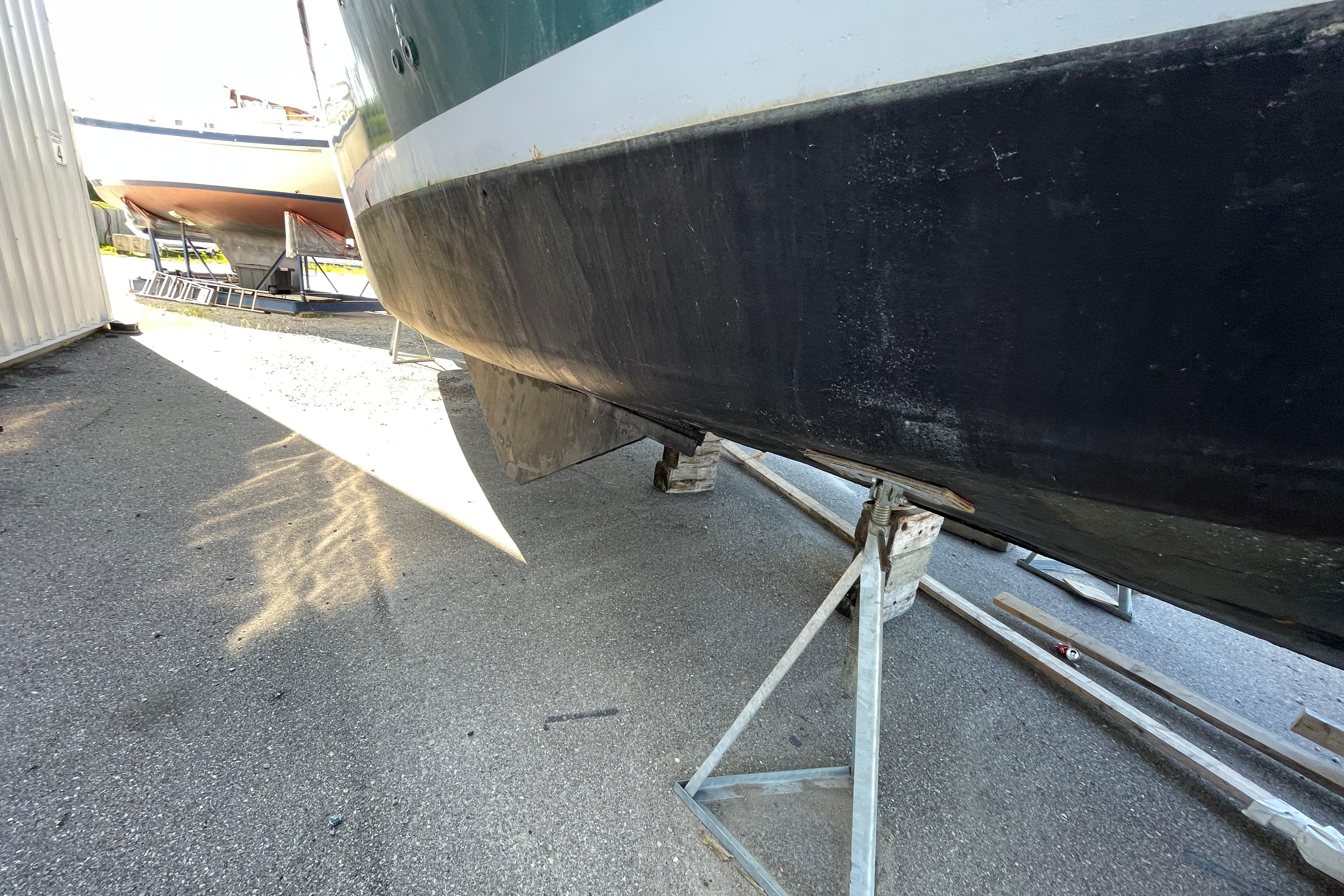 1966 Vinette 430 Trawler on stands, hull view in boatyard.