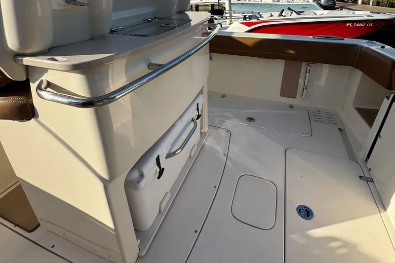  Yacht Photos Pics 2018 Scout 300 LXF boat interior with storage and seating area.