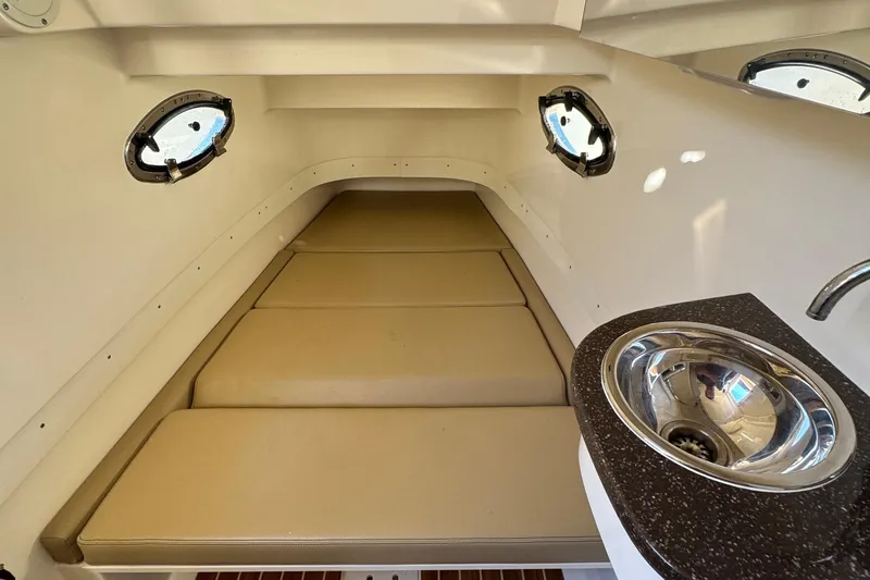  Yacht Photos Pics 2018 Scout 300 LXF cabin interior with beige cushions and stainless steel sink.