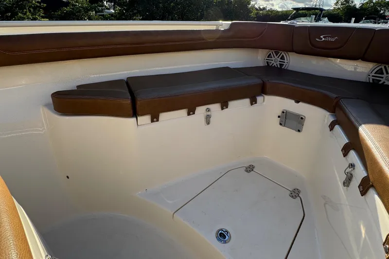  Yacht Photos Pics 2018 Scout 300 LXF boat interior with brown cushioned seating and storage compartments.