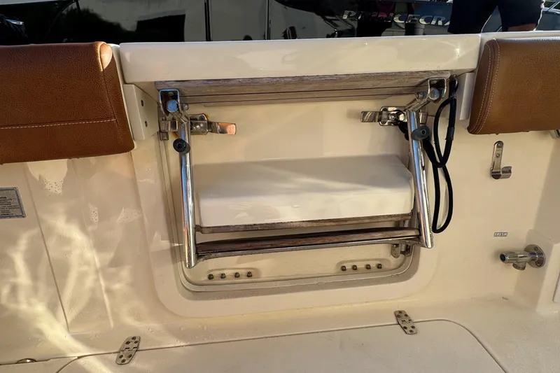  Yacht Photos Pics 2018 Scout 300 LXF boat ladder with stainless steel frame and brown accents.