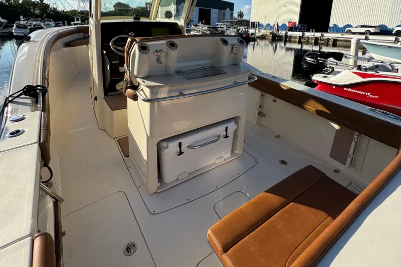  Yacht Photos Pics 2018 Scout 300 LXF boat interior with seating and helm station at marina.