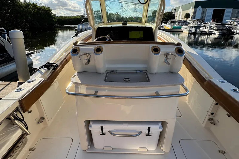  Yacht Photos Pics 2018 Scout 300 LXF boat interior with fishing rod holders and storage.
