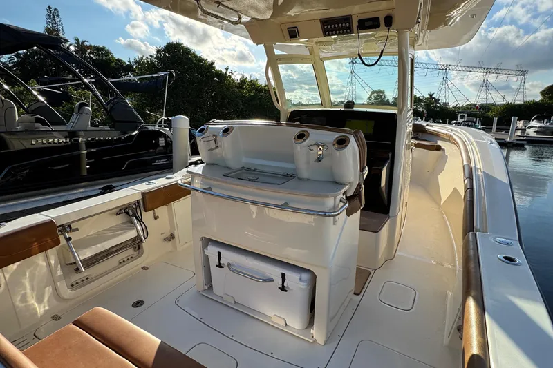  Yacht Photos Pics 2018 Scout 300 LXF boat interior with seating and control panel, docked at marina.