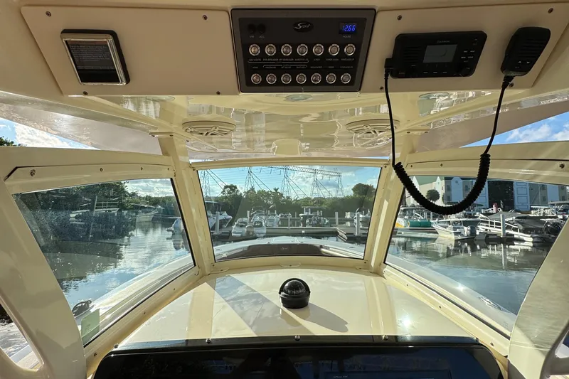 Yacht Photos Pics Interior view of 2018 Scout 300 LXF boat cockpit with marina in background.