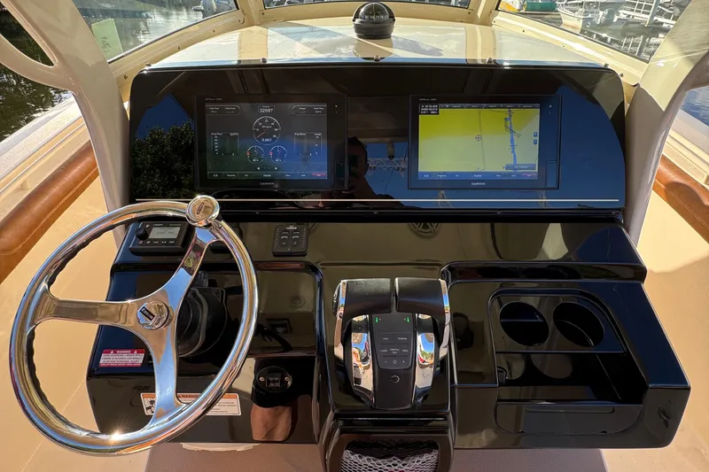 Yacht Photos Pics 2018 Scout 300 LXF boat dashboard with steering wheel and navigation screens.
