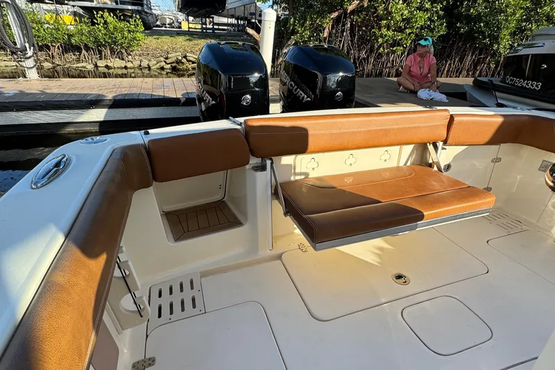  Yacht Photos Pics 2018 Scout 300 LXF boat interior with brown seating and dual outboard motors.