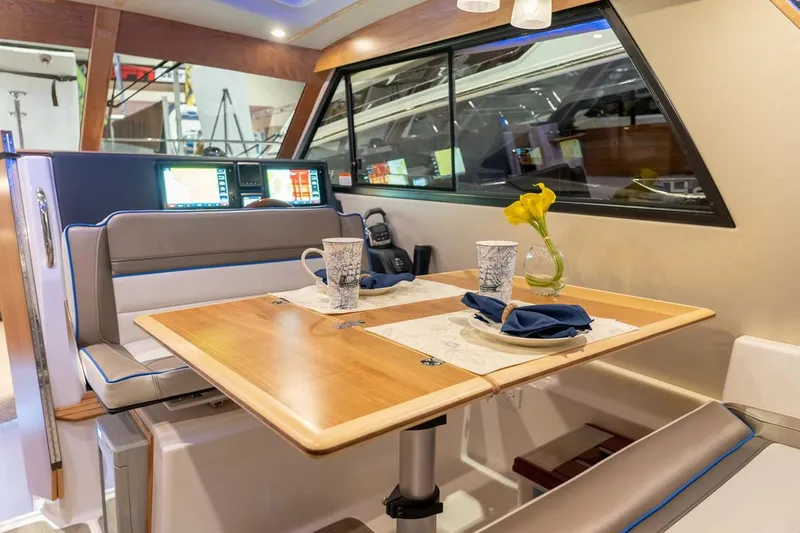 Ruff Life Yacht Photos Pics Manufacturer Provided Image: Interior of 2022 Cutwater C-30 Sedan with dining table and seating area.