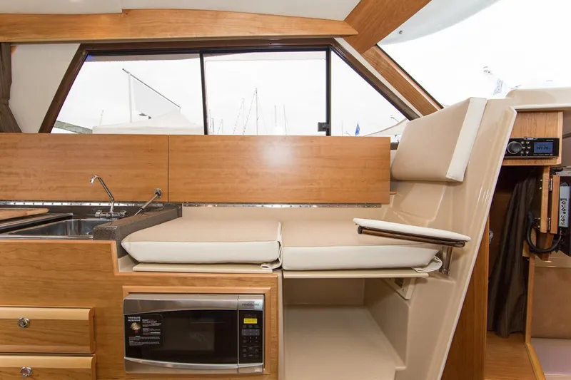 Ruff Life Yacht Photos Pics Manufacturer Provided Image: Interior of 2022 Cutwater C-30 Sedan with kitchen sink, microwave, and seating area.