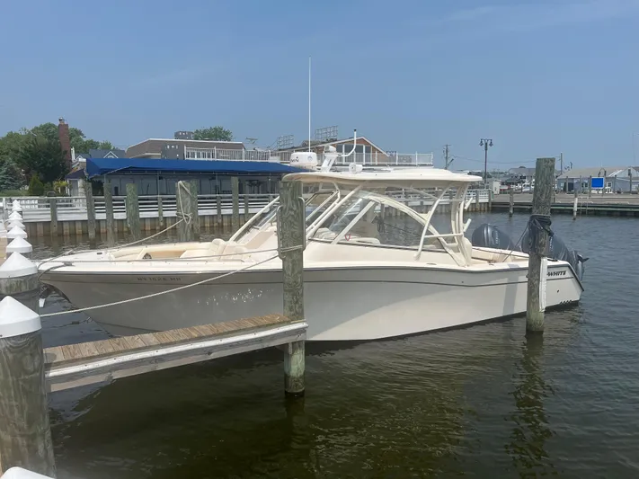  Yacht Photos Pics 2020 Grady-White Freedom 335 boat docked at a marina on a sunny day.