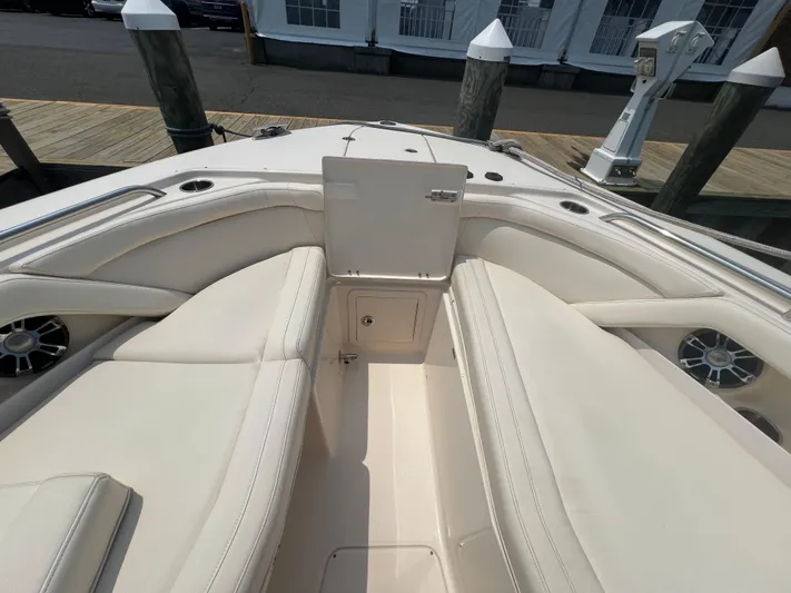  Yacht Photos Pics 2020 Grady-White Freedom 335 boat interior with beige seating and storage compartment.