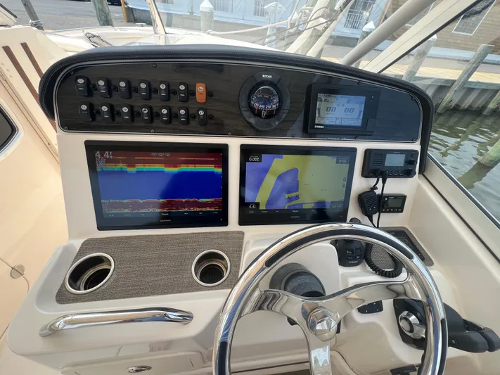  Yacht Photos Pics Control panel of 2020 Grady-White Freedom 335 boat with navigation screens and controls.