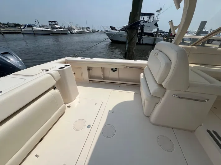  Yacht Photos Pics 2020 Grady-White Freedom 335 boat interior, featuring spacious seating and docked at a marina.
