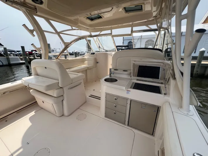  Yacht Photos Pics 2020 Grady-White Freedom 335 boat interior with seating and kitchenette at marina.
