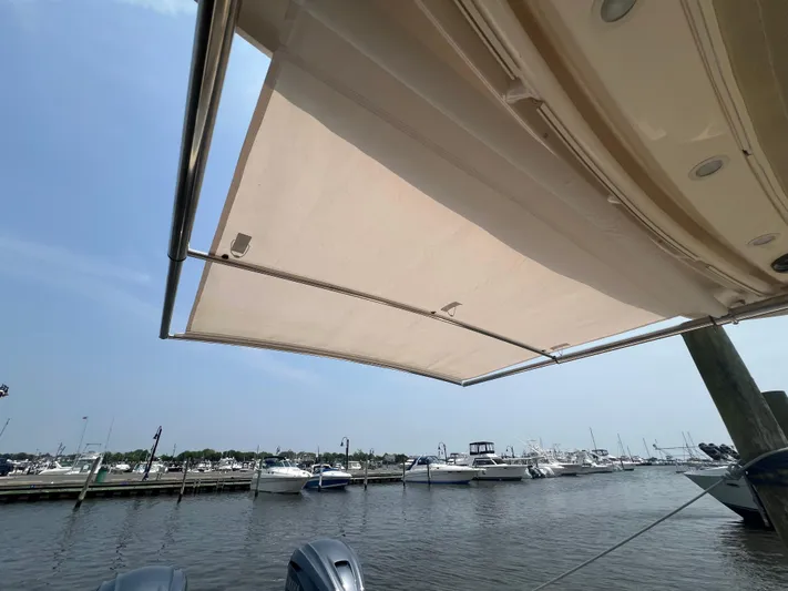  Yacht Photos Pics 2020 Grady-White Freedom 335 boat with extended sunshade at marina.