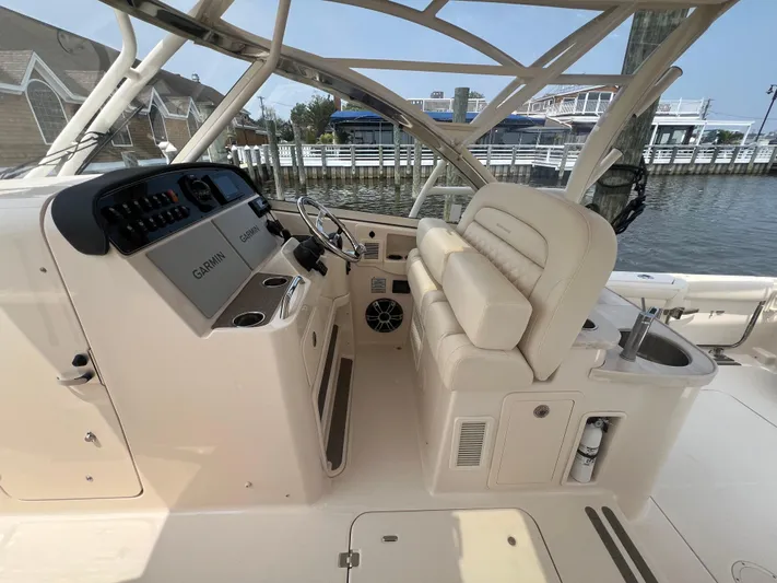  Yacht Photos Pics 2020 Grady-White Freedom 335 boat interior with helm and seating area.