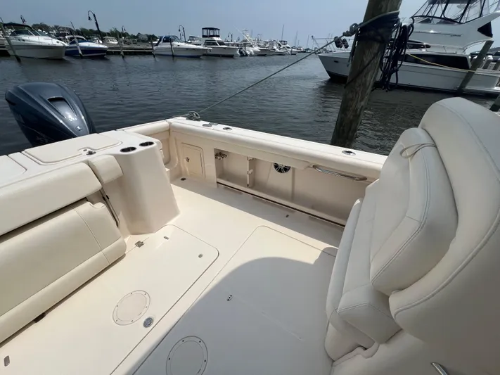  Yacht Photos Pics 2020 Grady-White Freedom 335 boat interior at marina, showcasing seating and deck area.