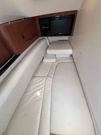  Yacht Photos Pics 2020 Grady-White Freedom 335 cabin interior with white seating and wooden accents.