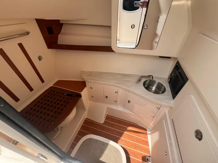  Yacht Photos Pics 2020 Grady-White Freedom 335 boat interior with sink, cabinets, and wooden flooring.