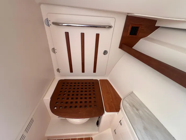  Yacht Photos Pics 2020 Grady-White Freedom 335 boat interior with wooden accents and modern design.